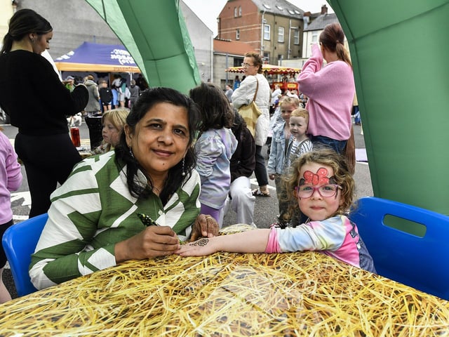 Young girls gets a Henna design at the Gasyard Feile’s Big Bog BBQ held at Pilot’s Row Centre on Saturday afternoon. Photo: George Sweeney