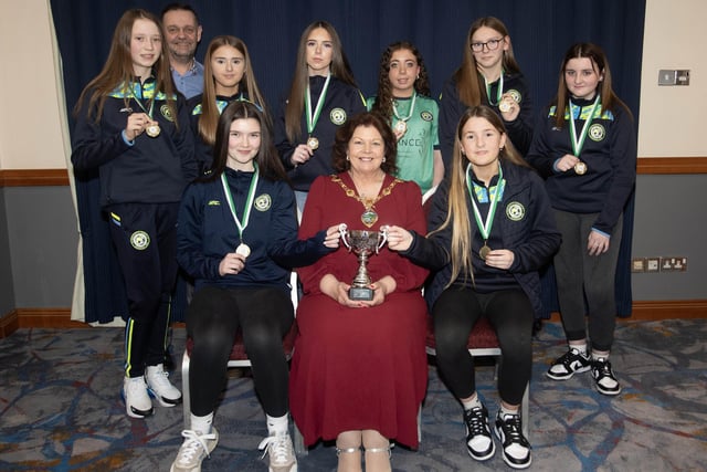 The Mayor of Derry City and Strabane District Council, Patricia Logue presents the Winter Cup to winners Sion Swifts u-14s. Included is coach Darren Crozier.