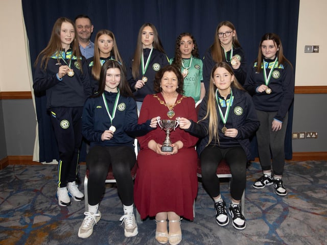 The Mayor of Derry City and Strabane District Council, Patricia Logue presents the Winter Cup to winners Sion Swifts u-14s. Included is coach Darren Crozier.