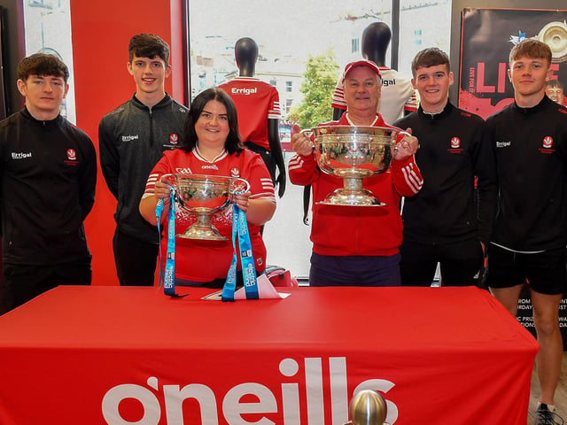 Aine and Dermot McElholm pictured with members of Derry's All-Ireland Minor Champions team at O'Neill's Superstore last week. Photo: George Sweeney