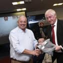 Derry County Chairman John Keenan makes a presentation to Dungiven's Colm McGuigan at the reunion on Friday night.