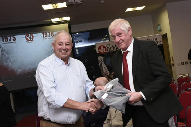 Derry County Chairman John Keenan makes a presentation to Dungiven's Colm McGuigan at the reunion on Friday night.