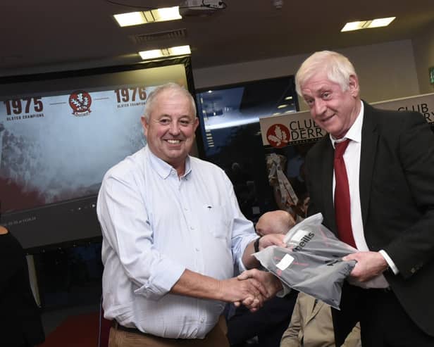 Derry County Chairman John Keenan makes a presentation to Dungiven's Colm McGuigan at the reunion on Friday night.
