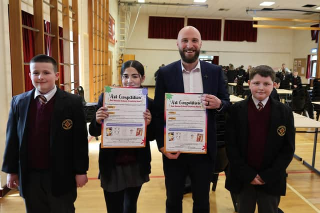 Helping launch the North West Migrants Forum’s Anti-Racism Art Competition are St Brigid’s College students Peter, Grace and Jayden along with teacher Ciaran Quigley.