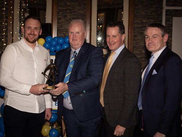 Stephen Gillespie, GAA Champion 15 All Star and Tir Chonaill Centurion 2024, receives his trophy from Liam Gallagher, Club Chair. Included on right are Cormac Hartnett, County Board Hurling Officer and Ciaran McLaughlin, former Ulster President.