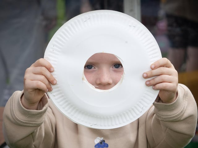 Daithi Campbell shows off his plate with the hole during Monday's Feile event in Creggan.