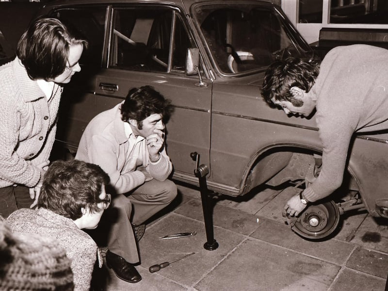 Chief Instructor Joe Halloway (on right) with enthusiasts at an adult car maintenance course at Carnhill High School.