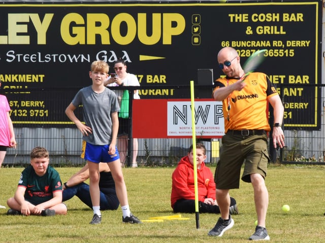 Mr Feeney demonstrating how it is to done as Riley watches on during the Steelstown PS Sports Day at Brian Og’s on Friday.