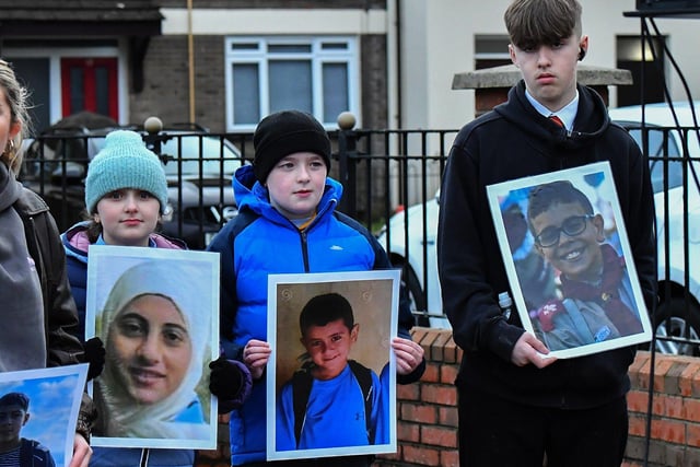 Eve Kelly, Nathan Kelly and Luke Doyle, young relatives of Michael Kelly, who was murdered on Bloody Sunday carry photographs of children killed in the West Bank by the Israeli military, at the one minute silence dedicated to the children of Gaza at the Bloody Sunday monument on Thursday afternoon. Photo: George Sweeney