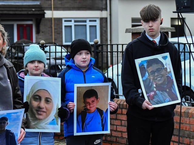 Eve Kelly, Nathan Kelly and Luke Doyle, young relatives of Michael Kelly, who was murdered on Bloody Sunday carry photographs of children killed in the West Bank by the Israeli military, at the one minute silence dedicated to the children of Gaza at the Bloody Sunday monument on Thursday afternoon. Photo: George Sweeney