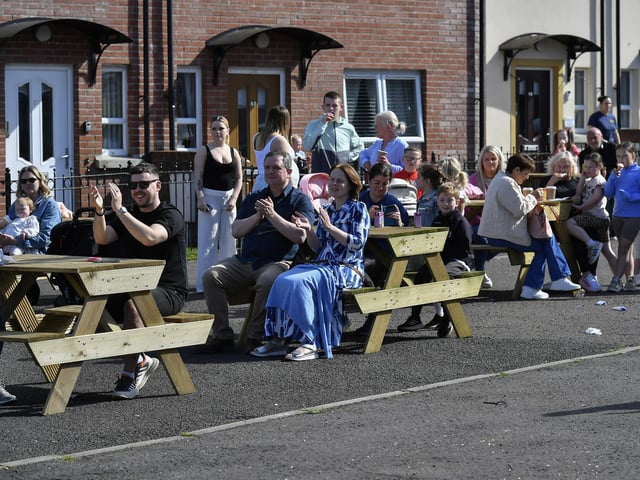 People enjoy the sunshine and the sounds of the Top Tier Brass Band playing in Meenan Square. Photo: George Sweeney
