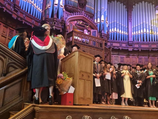 Professor Patricia Harris, Course Director at Ulster University's Graduate Entry Medical, receiving flowers from colleagues as the first cohort of doctors graduated from the Magee Medical School on Monday.