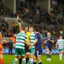 Referee Paul McLaughlin brandishes the first of two red cards on the night to Ed McGinty after the Rovers keeper handled outside his penalty area to deny Danny Mullen a chance.