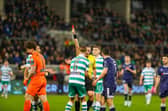 Referee Paul McLaughlin brandishes the first of two red cards on the night to Ed McGinty after the Rovers keeper handled outside his penalty area to deny Danny Mullen a chance.