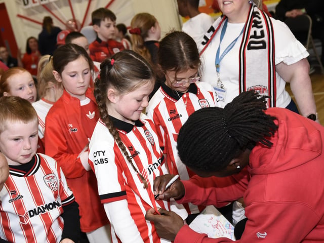 Derry City Football Player Kevin dos Santos signing some of the kids' tops.