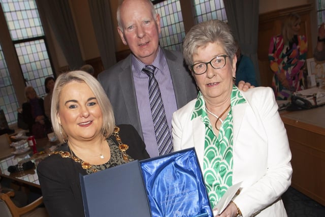 The Mayor of Derry City and Strabane District Council, Sandra Duffy pictured making a presentation to Strabane’s Ursula Melaugh at the Guildhall, Derry on Tuesday evening in recognition of her caring service to the Strabane community. Centre is Ursula’s husband Joe. (Photos: Jim McCafferty Photography)