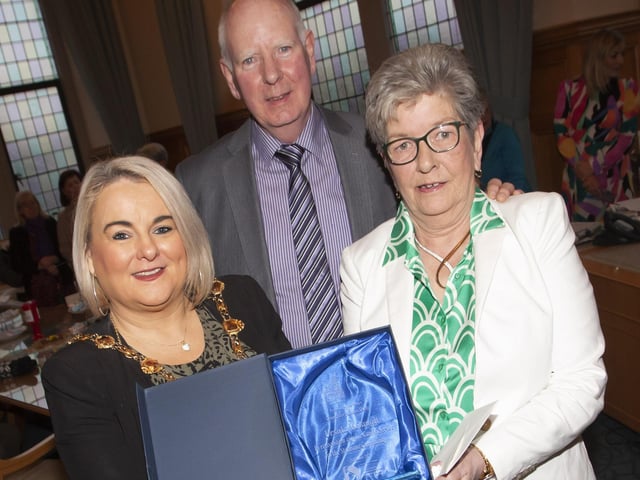The Mayor of Derry City and Strabane District Council, Sandra Duffy pictured making a presentation to Strabane’s Ursula Melaugh at the Guildhall, Derry on Tuesday evening in recognition of her caring service to the Strabane community. Centre is Ursula’s husband Joe. (Photos: Jim McCafferty Photography)