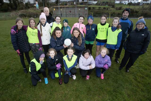 Donegal players Tara and Niamh Hegarty pictured with the U12 girls alongside Beart coaches Conor Gallagher, Shane McDaid and Joanne McKinney. Photo: Jim McCafferty Photography