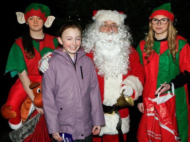 Erin Feeney with Santa and his elves.