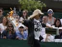 A Just Stop Oil protester runs onto Court 18 and releases confetti