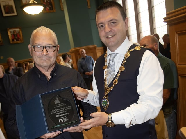 The Mayor of Derry City and Strabane District Council, Ruairi McHugh making a presentation to Martin 'Gills' McGilloway, chair of the Eamonn 'Bronco' Bradley Football Tournament Committee in recognition of their 40th anniversary on Friday evening at the Guildhall. (Photos: Jim McCafferty Photography) : .