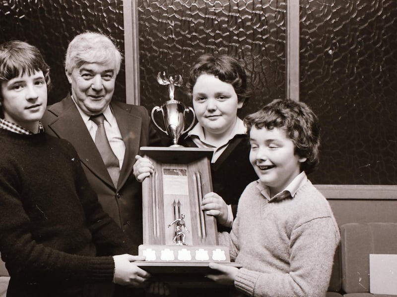 Michael, left, and Patrick Condren presenting the Jim Condren Memorial Trophy to Gary Fleming, captain of the Tristar FC under-14 team, at the D&D presentations. The boy's father, Mr. Fonsie Condren, who donated the trophy is in the photograph.