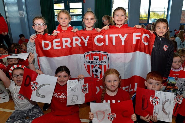 Pupils from St Eithnes Primary School welcome Derry City defenders Daniel Laffery and Ciaran Coll  during a visit to the school, with the FAI Cup, on Wednesday morning. Photo: George Sweeney.  DER2246GS  080