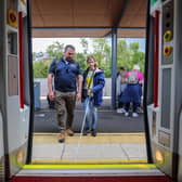 Pictured L-R: Anthony O'Neill, Guide Dogs NI, with Elodie, boarding a Translink train service from Derry~Londonderry.:Visually impaired young people enjoy public transport experience