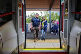 Pictured L-R: Anthony O'Neill, Guide Dogs NI, with Elodie, boarding a Translink train service from Derry~Londonderry.:Visually impaired young people enjoy public transport experience