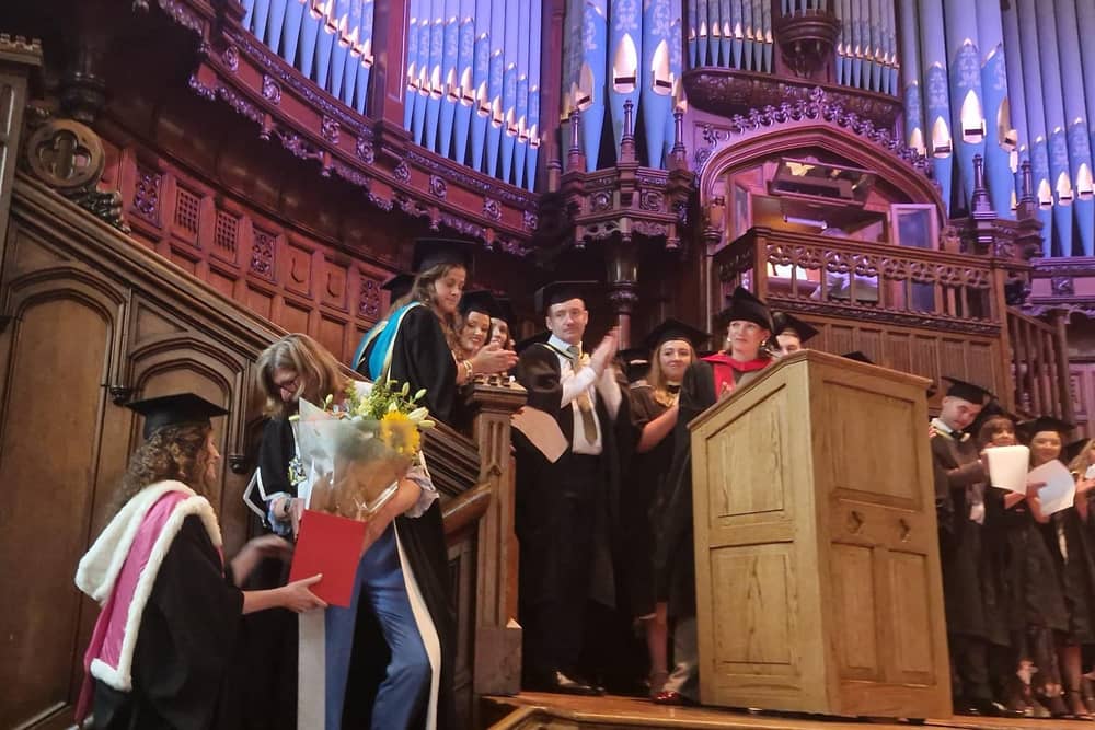 Professor Louise Dubras, receiving flowers from colleagues as the first cohort of doctors graduated from the Magee Medical School on Monday.