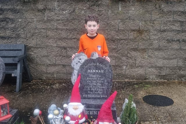 Kian Sweeney at the grave of his little sister Hannah, who passed away 10 years ago.
