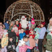 Mayor Patricia Logue, Santa and some of the spectators from Friday's Christmas light procession