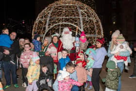 Mayor Patricia Logue, Santa and some of the spectators from Friday's Christmas light procession