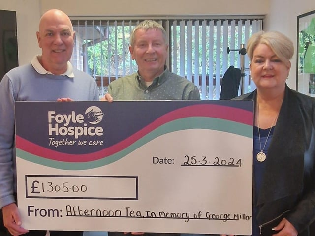 Helen Strain pictured with husband Stephen presenting a cheque for £1305 to Noel McMonagle, Foyle Hospice, in memory of her brother George Millar. This donation is to mark George’s 1st Anniversary, proceeds of an Afternoon Tea fundraiser, supported by his family, friends and members of Cakes Bakes & Cooking with George.