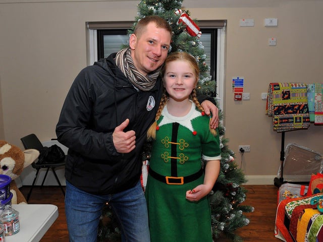 Colly McLaughlin with his daughter Faela at the Galliagh Community Response Christmas Craft Fair held in Pio House Parish Centre on Saturday, in aid of Foyle Down Syndrome Trust. Photo: George Sweeney. DER2250GS – 85