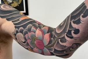 Aged 28 from Killea Donegal."This particular piece stands out for me due to its simplicity, using only two subjects, a limited colour palette, basic yet strong line work reinforced by a dark background which helps make the piece flow, complementing the area of the body. I love how this piece finishes 3/4 of the way down the arm, I’ve always thought there was something very appealing and classy about traditional Japanese style tattoos, especially how they’re finished at the edges. My client Lee gave me a loose brief and a lot of freedom with design, which made the whole process a breeze. When creating a tattoo I ask myself “how will this tattoo look in 10 years?”, with longevity in mind I remove anything that may not age well, so I hope this piece stands the test of time! I’ve been a tattoo artist for about 7 years, I started my apprenticeship in Studio 76 right after graduating in product design at University of Ulster, Belfast.Black Swan Tattoo.Having an art background I always toyed with the idea of being a tattoo artist since I started getting tattooed at 18, but only decided to bite the bullet and go for it after a tattoo session with Andy Moore, which lead to an opportunity to start an apprenticeship, I graduated a few weeks prior so the timing was perfect. I’ve loved tattooing ever since!"
