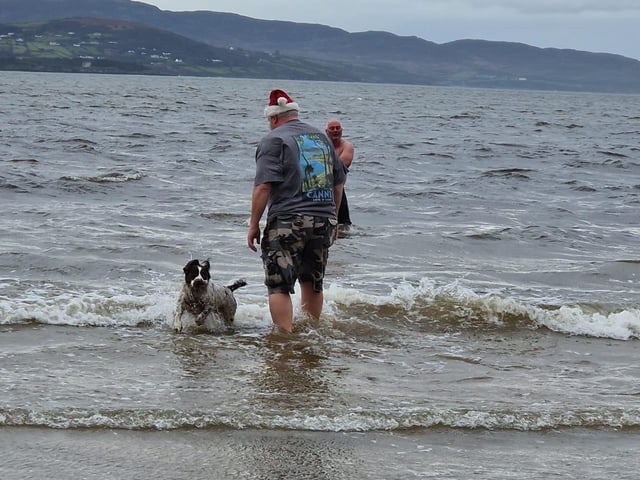 John Duffy and his dog enojying a festive dip on Christmas Day.