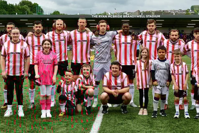 The Derry City team and mascots pictured before kick-off at Brandywell.