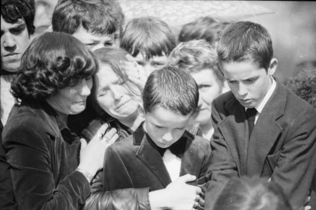 Maria McConomy with her sons Emmett and Mark at the funeral of her 11-year-old boy Stephen who was killed by a British soldier on April 16, 1982.