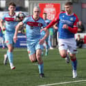 Linfield's Ethan Magee  and Institute's Oisin Devlin