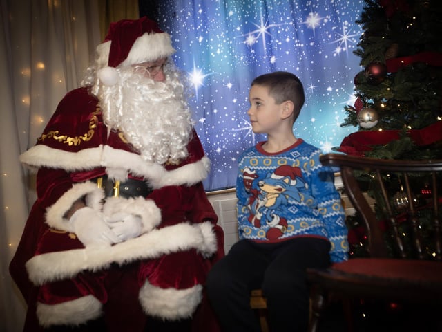 This young man getting his list to Santa Claus and collecting a present on Saturday at Derry Credit Union. : .