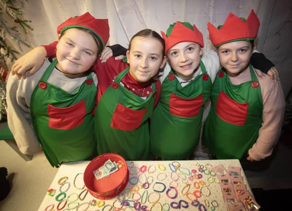 SANTA'S ELVES. . . . .Some of the P7 girls helping out during Thursday night's event in Holy Child PS.