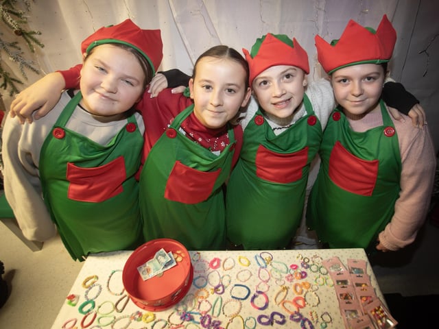 SANTA'S ELVES. . . . .Some of the P7 girls helping out during Thursday night's event in Holy Child PS.