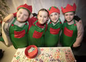 SANTA'S ELVES. . . . .Some of the P7 girls helping out during Thursday night's event in Holy Child PS.