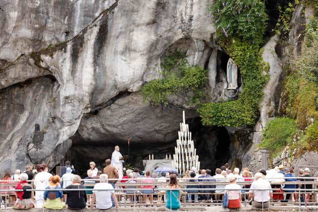 People attend a mass at the catholic shrine of Lourdes. (Photo by Ludovic MARIN / AFP) (Photo by LUDOVIC MARIN/AFP via Getty Images)