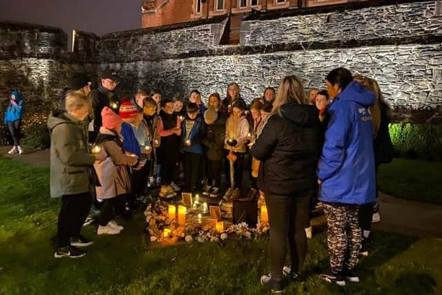 Young people below the Derry Walls working on 'A Night to Remember'.