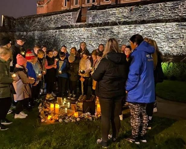 Young people below the Derry Walls working on 'A Night to Remember'.