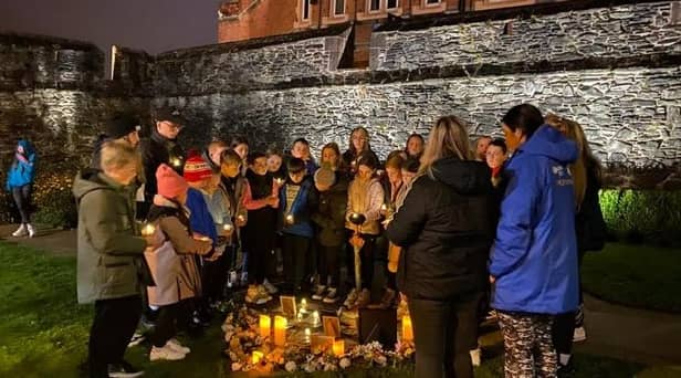 Young people below the Derry Walls working on 'A Night to Remember'.