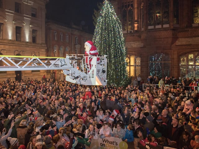 Santa passes out some sweets to the thousands of people in Derry's Guildhall Square after he arrived to switch on the Christmas lights. Picture Martin McKeown. Inpresspics.com. 22.11.18