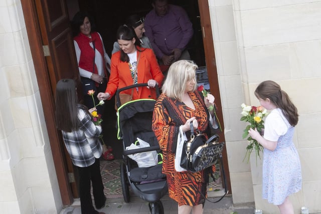 Children handing out flowers at the end of Sunday’s Sister Clare Crockett Retreat in the Long Tower Church.